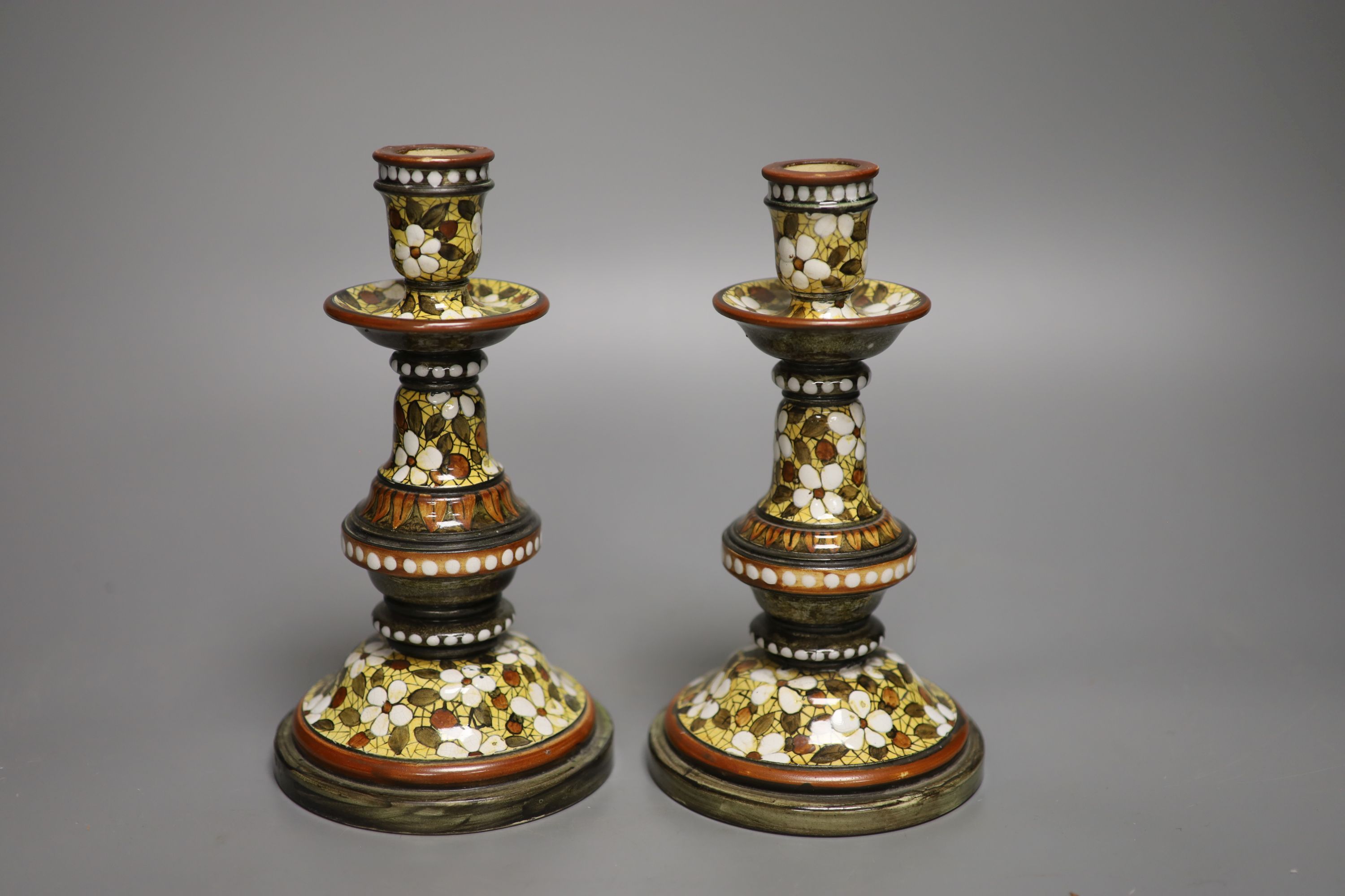 A pair of Doulton Lambeth candlesticks, decorated by Mary Butterton, height 20cm
